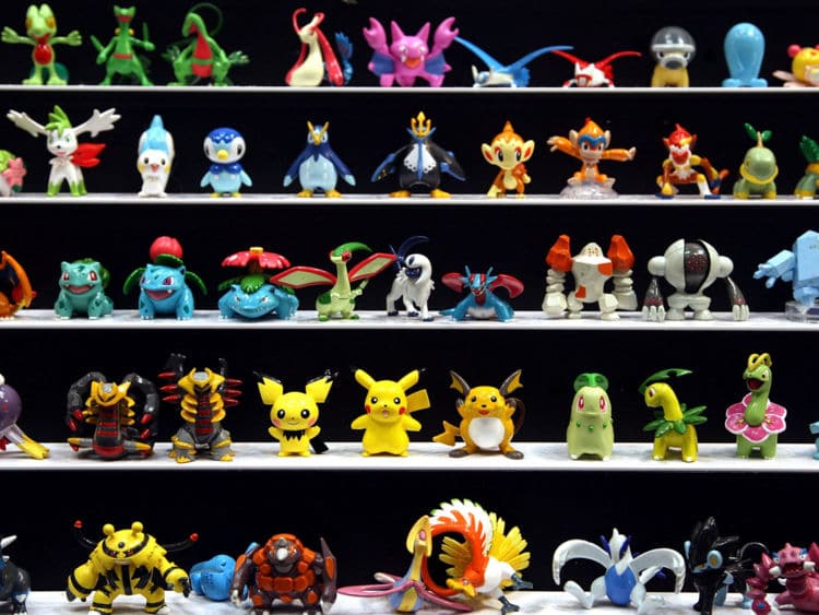 Assorted Pokémon figures displayed on tiered shelves, suitable for exhibition or themed event decor.