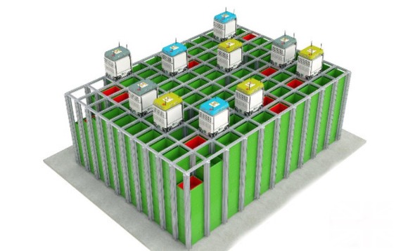 Automated warehouse with stacked storage bins and robotic units on grid-based tracks, optimizing logistics and inventory management.